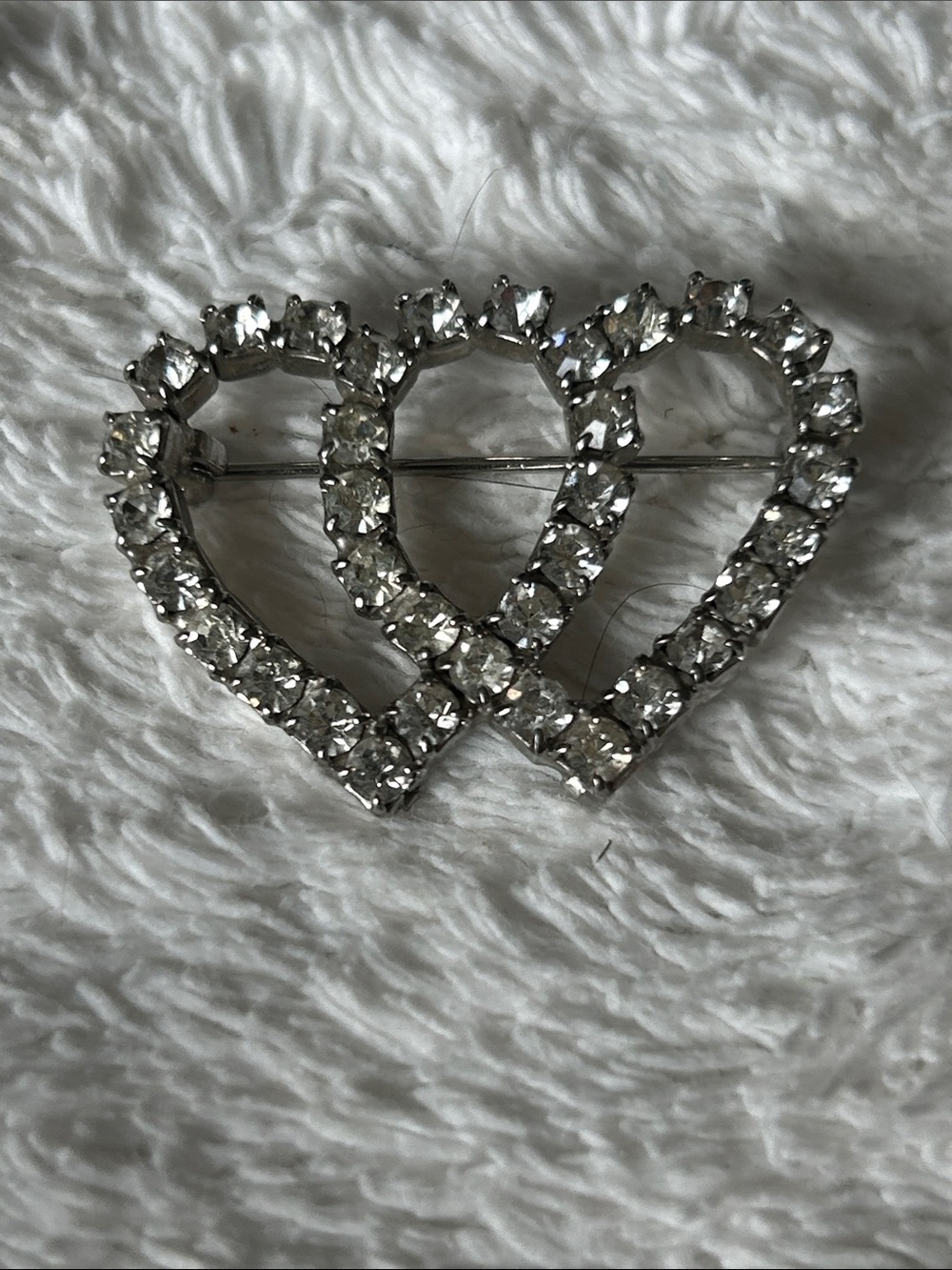 Double rhinestone open heart pin.